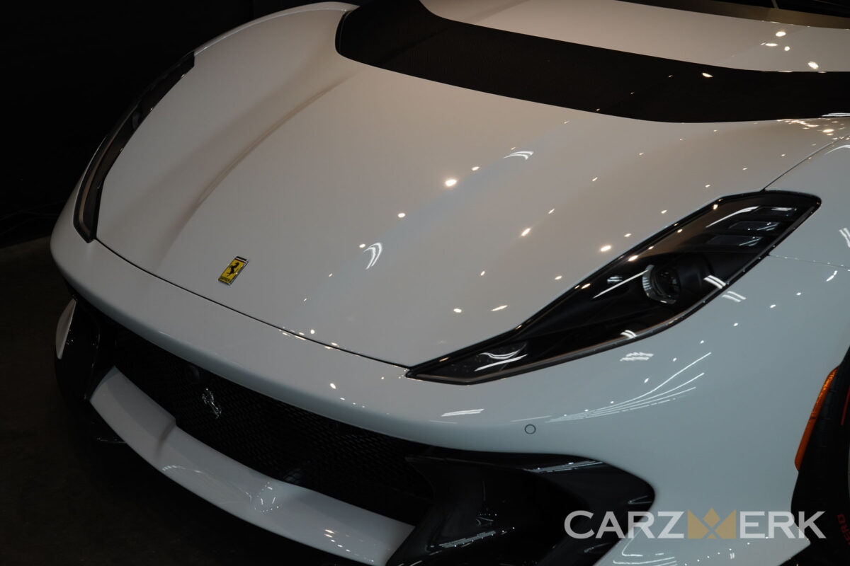 A protected paint finish on a white sportscar.