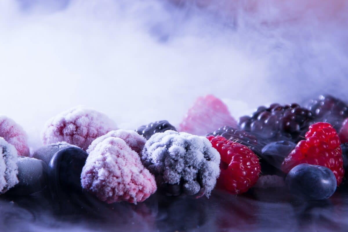 Mixed berries frozen in dry ice for preservation.