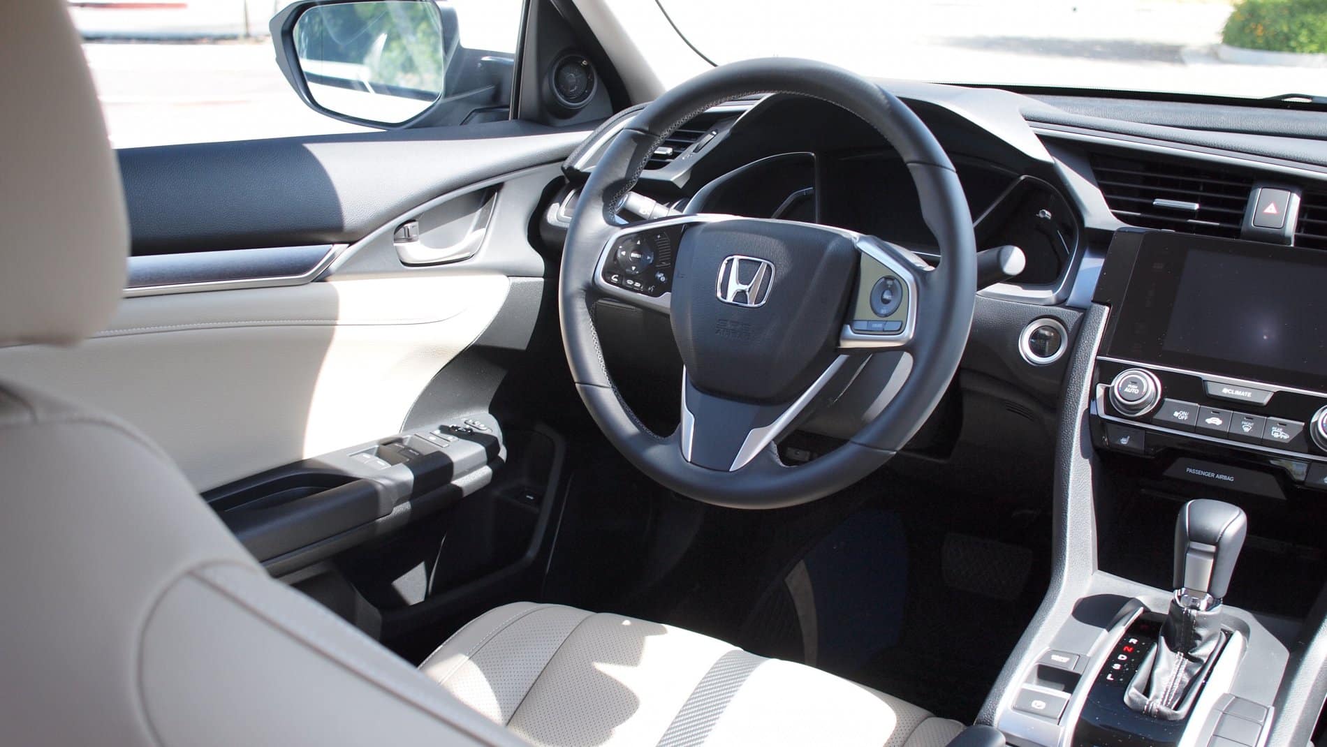 Honda Civic white interior in the partial sunlight. The darker parts of the interior are at risk of fading.