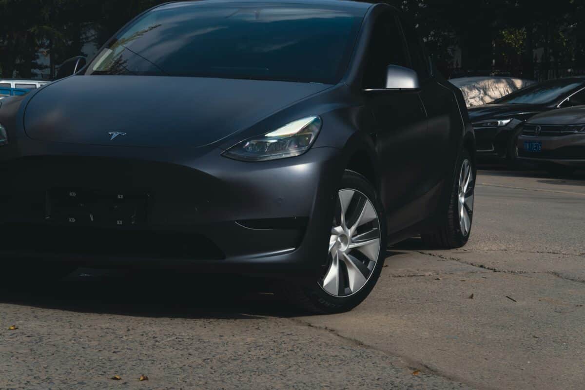 Stealth PPF on a Tesla Model Y, which is parked in a concrete parking lot.