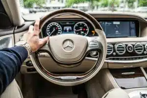 A steering wheel from the driver's perspective. The beige luxury car interior has a high initial value, but why do Mercedes-Benz depreciate so much?