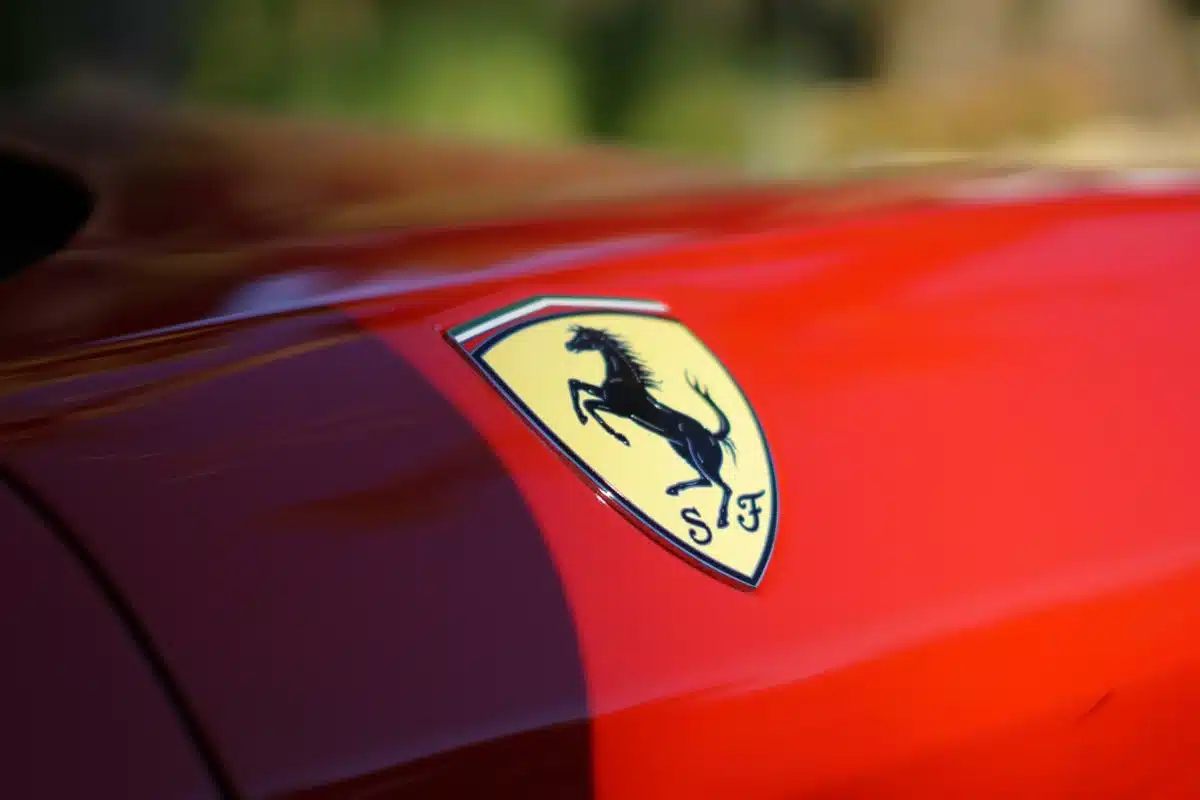 A Ferrari logo on a red vehicle after some luxury car detailing.