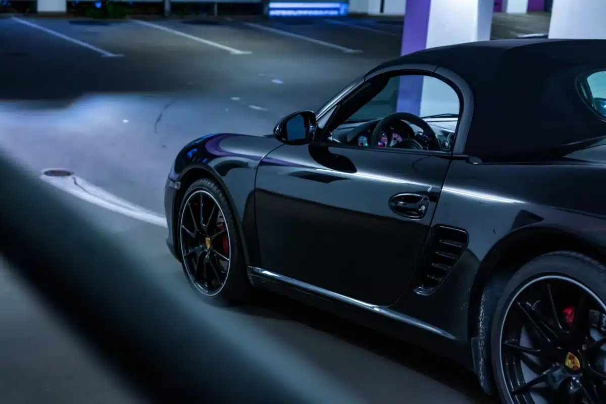 A Black Porsche parked inside a parking garage.