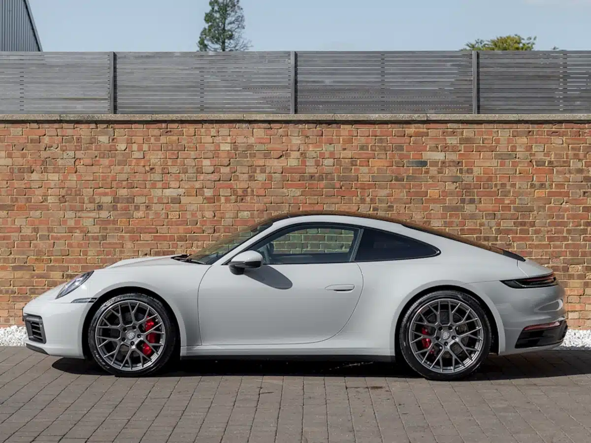 Chalk Porsche exterior colors on full display on a Porsche outside on a bright day.