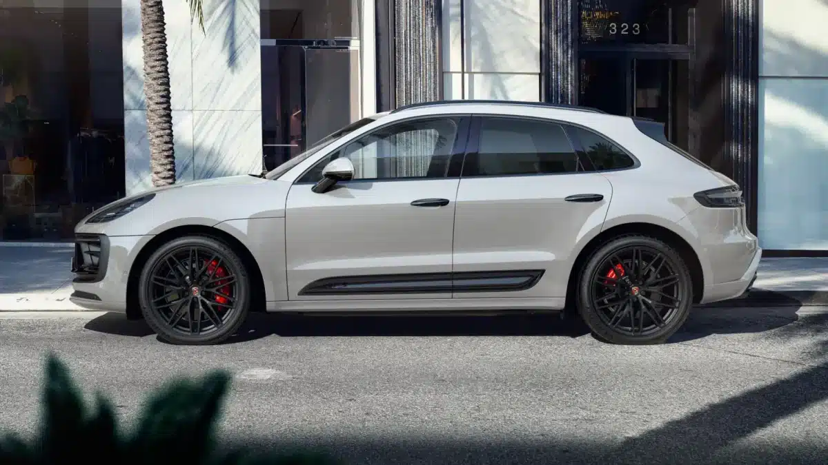 A Porsche Macan Chalk Color parked on a street outside.