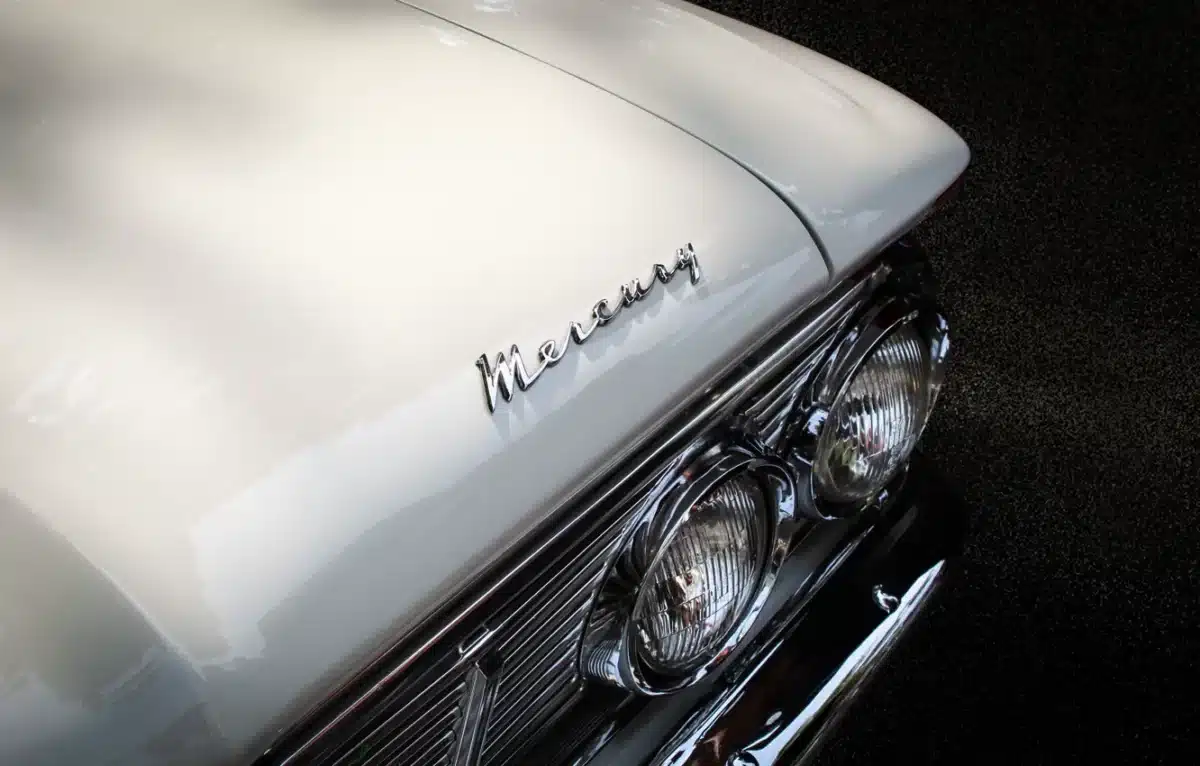 A close up of a detailed classic car. It's a white Mercury. 