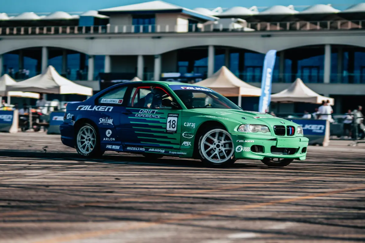 A factory stock car with a blue and teal gradient on it.