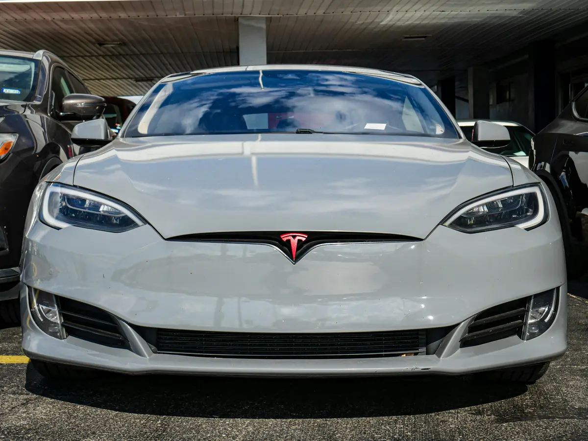 A front view of a white Tesla with ceramic coating for long term Tesla paint protection.