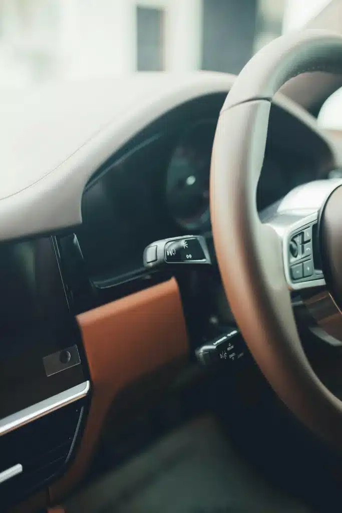 A steering wheel of a Porsche Cayenne.