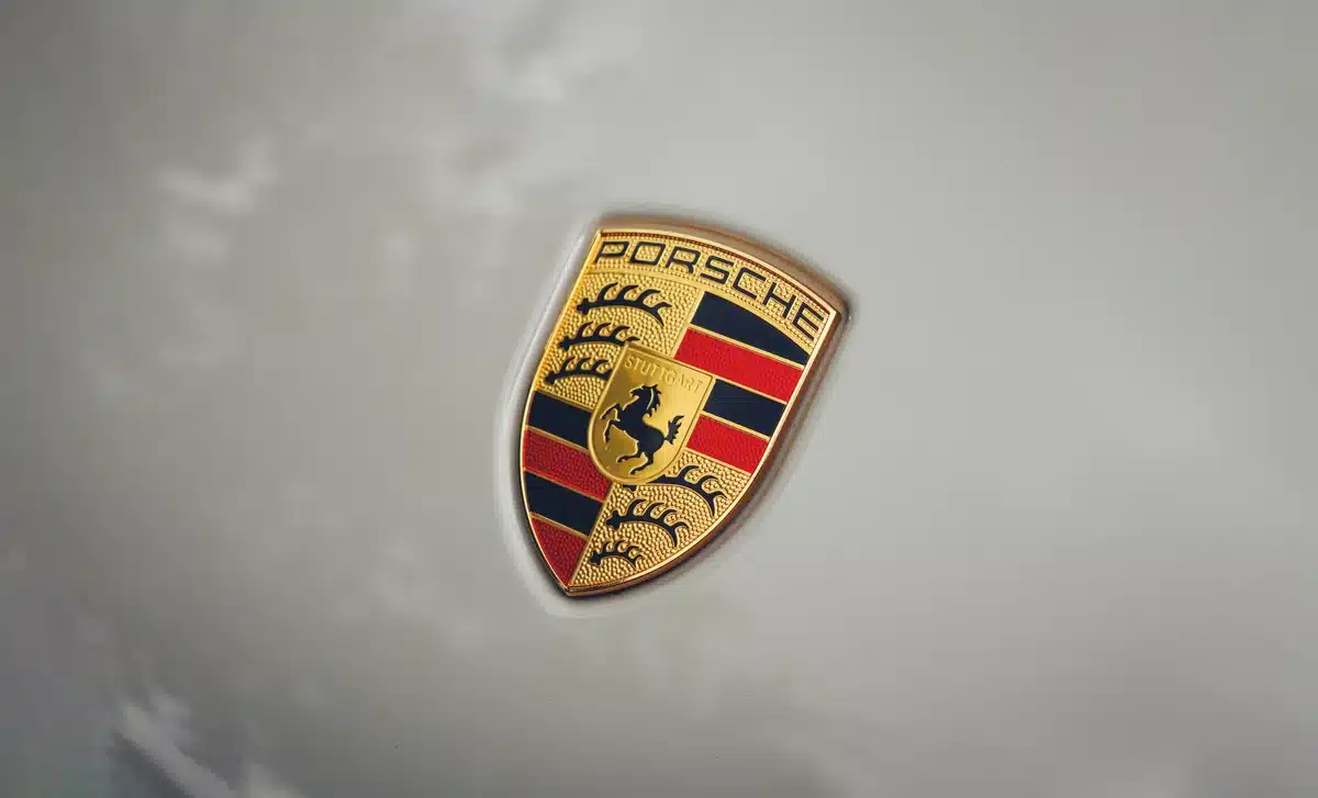 A close up of a Porsche emblem on a grey Porsche Macan with PPF installed so clean you can't see it.
