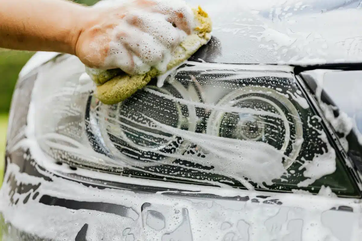 A close up of someone washing a car's headlight near Pleasanton, CA.