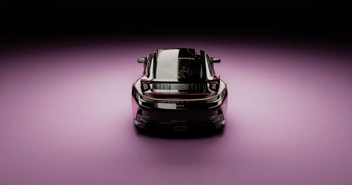 A black Porsche after tire and wheel protection services parked on a violet backdrop, pictured from above.